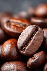 Dark roasted coffee beans close up on a textured surface showcasing rich colors and natural oils