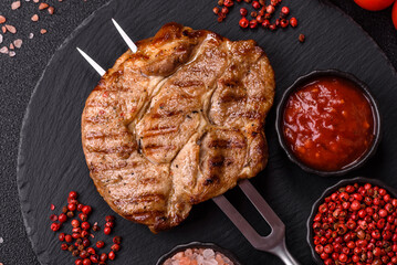 Grilled beef or pork steak, healthy restaurant food for lunch. Barbecue steak as a background
