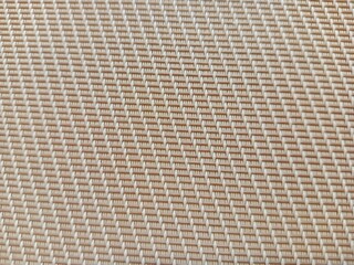A close-up of the synthetic woven mat texture. Featuring a regular geometric pattern, it's perfect as a cream-colored backdrop for a modern design
