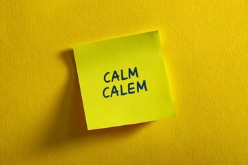 Highlighting a yellow sticky note with the words calm and calem written in blue ink