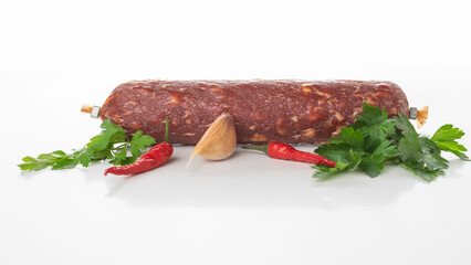 Spicy Salami with Red Chili Peppers, Garlic, and Fresh Parsley on White Background