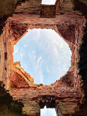 A brick building with a hole in the middle.