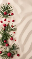 Tropical Christmas scene with green palm leaves and red ornaments arranged on a sandy background. A festive and vibrant holiday decoration concept.