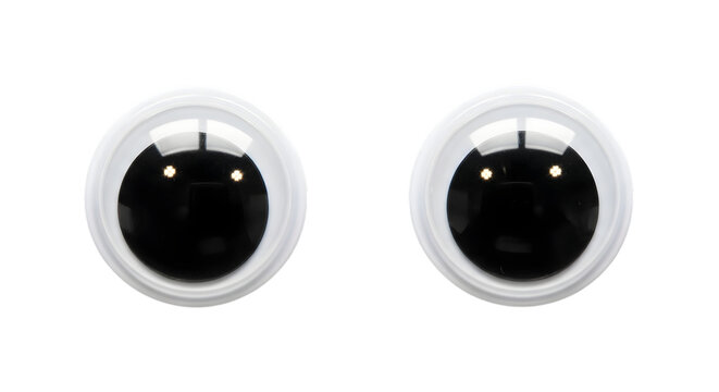 Two cartoon googly eyes with black pupils and white oval surrounds isolated on transparent background