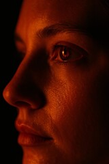 Naklejka premium Close up portrait with dramatic orange side lighting