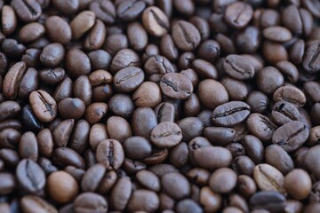Pile of fresh roasted brown coffee beans close up. Food photo for backdrops