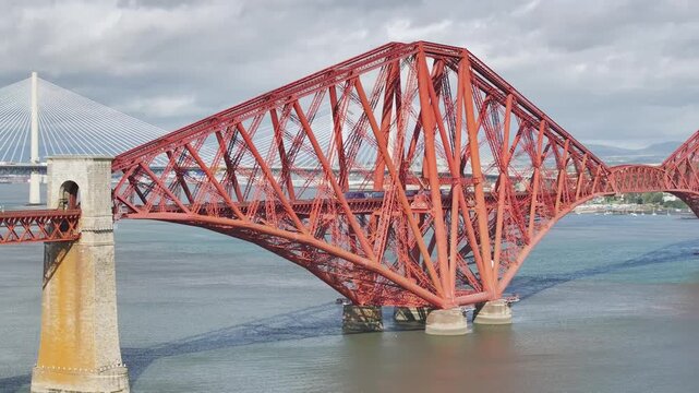 Trains on Forth Bridge from a drone, Queensferry Crossing, Forth Estuary, Scotland