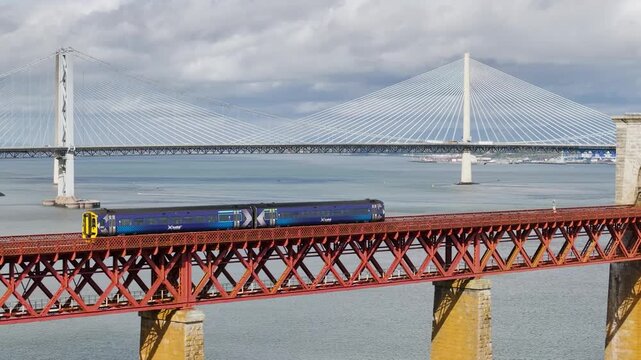 Trains on Forth Bridge from a drone, Queensferry Crossing, Forth Estuary, Scotland