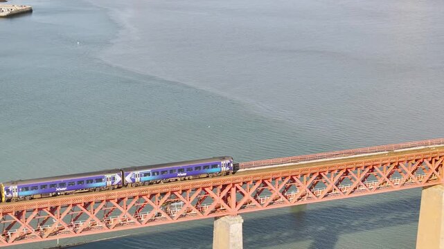 Trains on Forth Bridge from a drone, Queensferry Crossing, Forth Estuary, Scotland