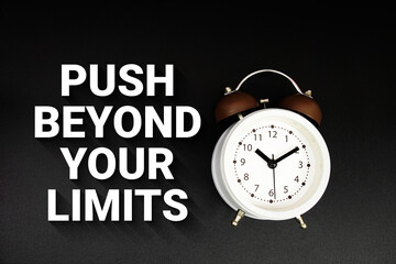 Push Beyond Your Limits text with alarm clock on black background