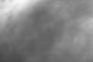 Soft gray fog envelops the landscape during early morning hours creating a serene atmosphere in the countryside