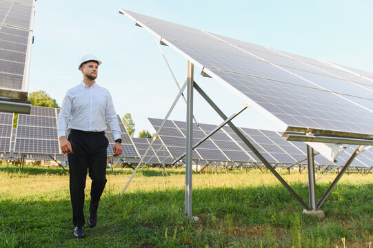 Engineer man walking solar panel farm
