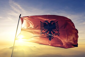 Albania albanian flag waving on the top sunrise mist fog