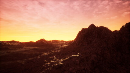 As night approaches, vibrant shades of gold and orange paint the horizon. Majestic mountains rise against the twilight sky, showcasing the beauty of natures transition from day to night.