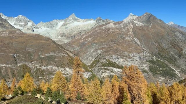 Take the Gornergrat Railway from Zermatt to the summit, with views of the autumnal landscape. Beautiful Swiss mountain scenery.