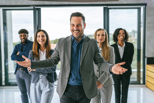 Diverse business team welcoming new members to office
