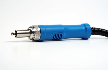 Blue hot air gun on white background. Soldering tool with black cord. Industrial equipment for electronics repair and manufacturing. Electric device with metal nozzle and plastic handle.