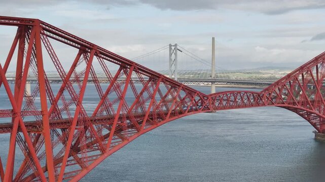 Trains on Forth Bridge from a drone, Queensferry Crossing, Forth Estuary, Scotland	