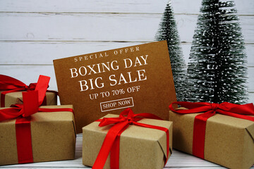Festive display with small decorative Christmas trees and gift box present with "Special Offer Boxing Day Big Sale up to 70% off, Promotion Holiday Sale Event