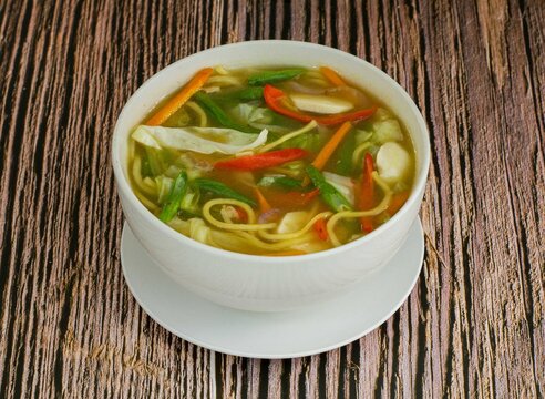 Warm Pancit Caldo Soup with Noodles and Vegetables