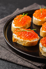 Fresh baguette canapes with red caviar and cream cheese