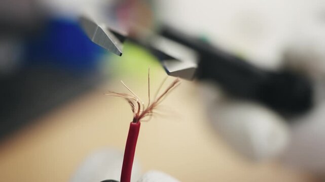 Close-up of measuring wire diameter with precision tool in a workshop