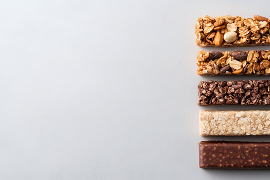 Variety of energy bars for a healthy lifestyle. Perfect snack for any activity, on a plain background. From granola to chocolate, a bar for every taste!