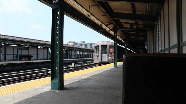 overhead above ground subway train passing train station in bensenhurst brooklyn new york city (nyc metro rail commuter line system) travel commute elevated tracks pass moving move cars car transport