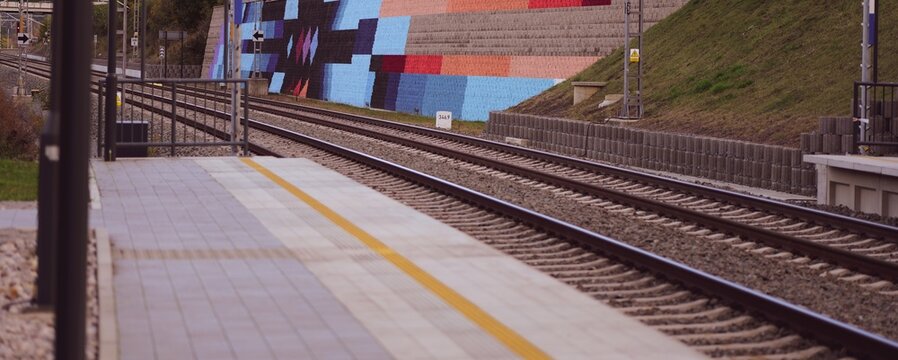 Train tracks run parallel on a platform. Ideal for transportation backgrounds