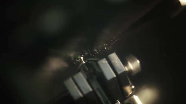 Detailed macro view of delicate cutting tool equipment working necessary for crimp control of precision cable production process