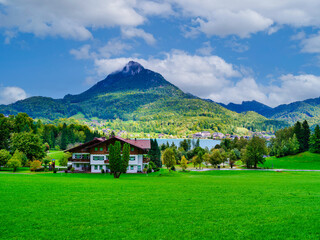 Scenic alpine village houses and lush rolling hills by Lake Wolfgangsee, Austria