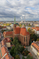 Aerial photograph of Wroclaw city in Poland, featuring the historic Gothic cathedral with its red roof and tall spire surrounded by colorful buildings.