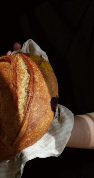 Freshly baked farm-style bread with colorful edible flowers, natural light, handmade and rustic.
