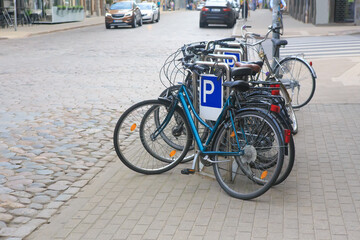 Bicycles parked on the sidewalk near an intersection