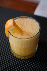 Freshly squeezed orange juice with vibrant pulp and a decorative wedge, perfect for a healthy breakfast or refreshing summer beverage anytime