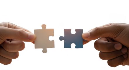 Hands connecting two puzzle pieces symbolizing collaboration teamwork and problem solving