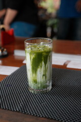 Refreshing matcha latte served with ice in a tall glass, perfect for a healthy lifestyle brand or trendy cafe promotion