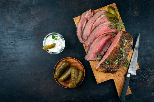 Traditional Commonwealth Sunday roast with sliced cold cuts roast beef with with cornichon pickle and relish remoulade sauce