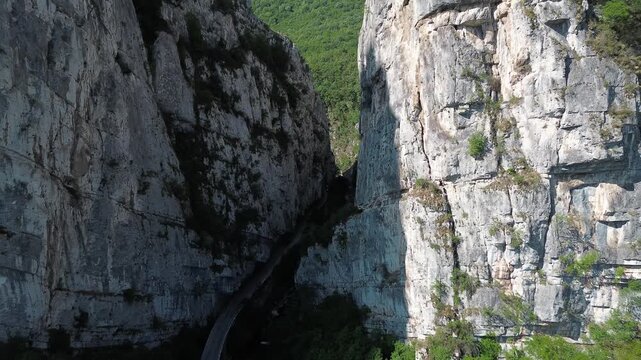Close aerial view of dramatic rocky cliffs in Jerma Canyon mountains, Serbia country, surrounded by dense forest. Horizontal 4k footage.