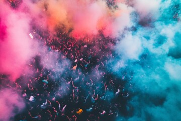 Colorful festival crowd with vibrant smoke effects in aerial view