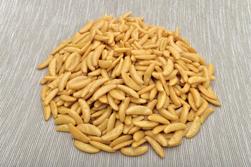 Japanese rice crackers kaki no tane on light gray textured surface.