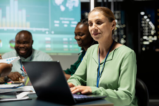 General manager in a night meeting analyzes global market data for a financial forecast and monthly updates, building a business strategy and establishing clear objectives. Female leader.