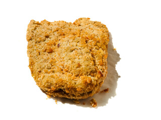 Fine breaded chicken breast fillet on white background. Classic poultry product. Uncooked meat covered with golden breadcrumbs.