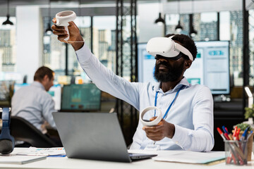 African american man in tech driven office using immersive VR headset for multinational company project presentation. Black male manager using virtual reality for innovative business strategy planning