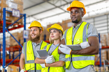 construction workers in warehouse. Female and male workers use tablet working in metal car part warehouse, import export, logistic business concept. Engineers checking spare part, transportation.
