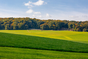Autumn landscape, Terrain hilly countryside in Zuid-Limburg with green grass field, farmland and forest under blue sky, Epen is a village in southern part of the Dutch province of Limburg, Netherlands