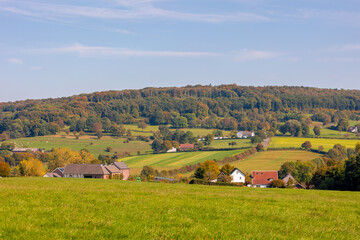 Fototapeta premium Autumn landscape, Terrain hilly countryside in Zuid-Limburg with a small villages on the hillside, farmland and forest, Epen is a village in southern part of the Dutch province of Limburg, Netherlands