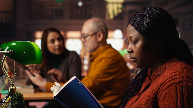 Colleagues disturbing a woman with their loud reading in the library, african american pupil making a noise complaint and being disturbed by the disrespect. Breaking the rules. - Powered by Adobe