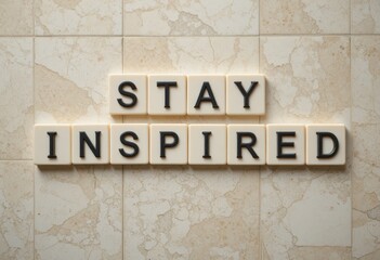 Stay Inspired Message on a Neutral Marble Background in Bright Letters