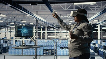 Data center technician using virtual reality, improving AI rigs processing speed. Server hub IT expert using VR headset to manage gear providing support for artificial intelligence workloads, camera A
